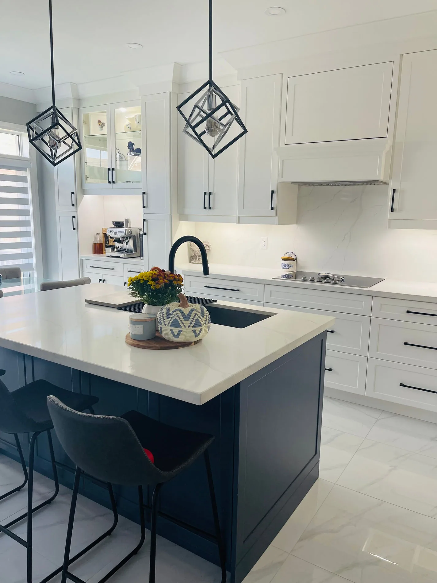 White kitchen with quartz island and custom cabinetry